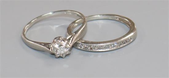 A platinum and illusion set diamond ring and a platinum and nine stone channel set diamond half eternity ring.